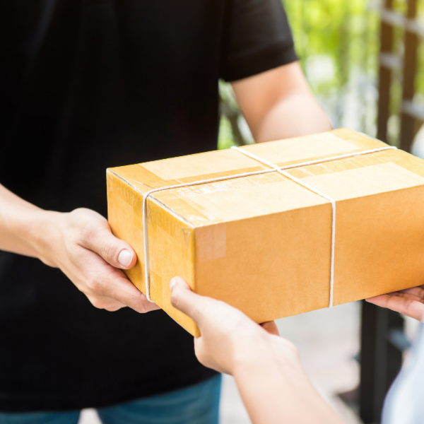 Use the mail to send participants goodies for your sponsors. Picture of a person handing over a package from the mail.
