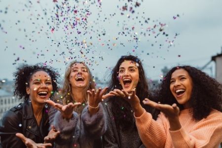 Show your volunteers appreciation. Image of 4 women celebrating with confetti.