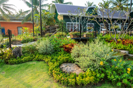 Membership Toolkit fundraising garden tour. Image of a beautiful garden in front of a house.